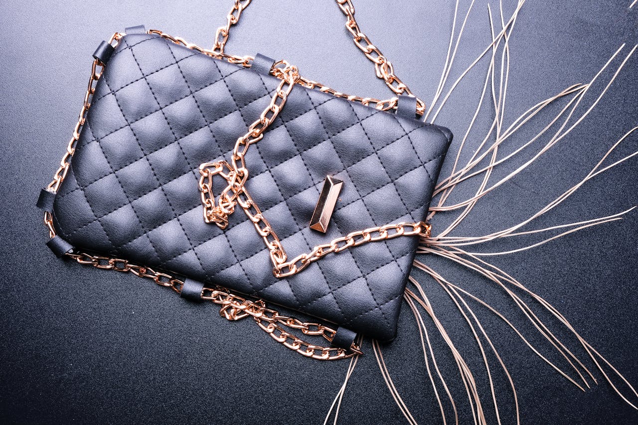 Stylish black quilted purse with gold chain detail, perfect for fashion and elegance.